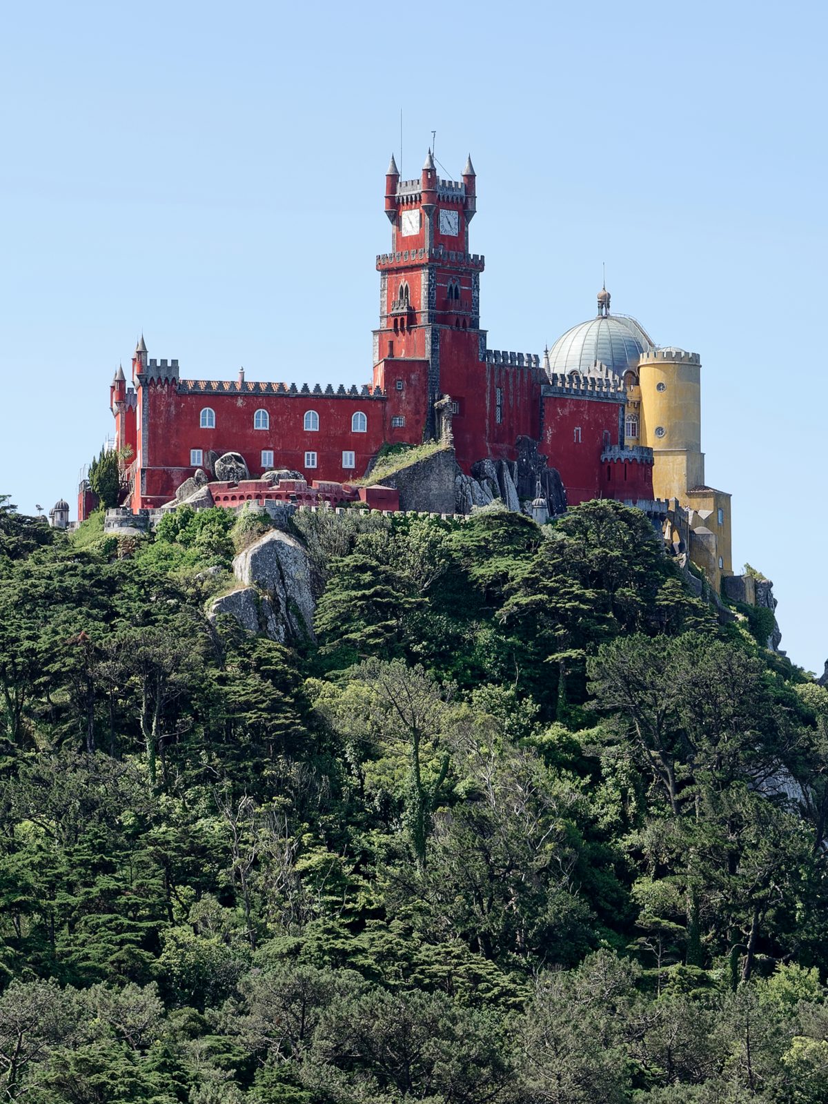 The red and yellow towers of the Pena Palace above the Sintra hills